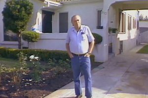 Charles Bukowski standing outside his childhood home in Mid-City Los Angeles